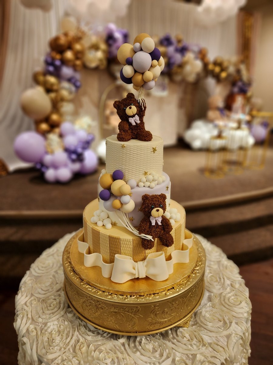 A teddy bear themed tiered birthday cake with balloons and gold stars from a custom birthday cake bakery in Indianapolis.