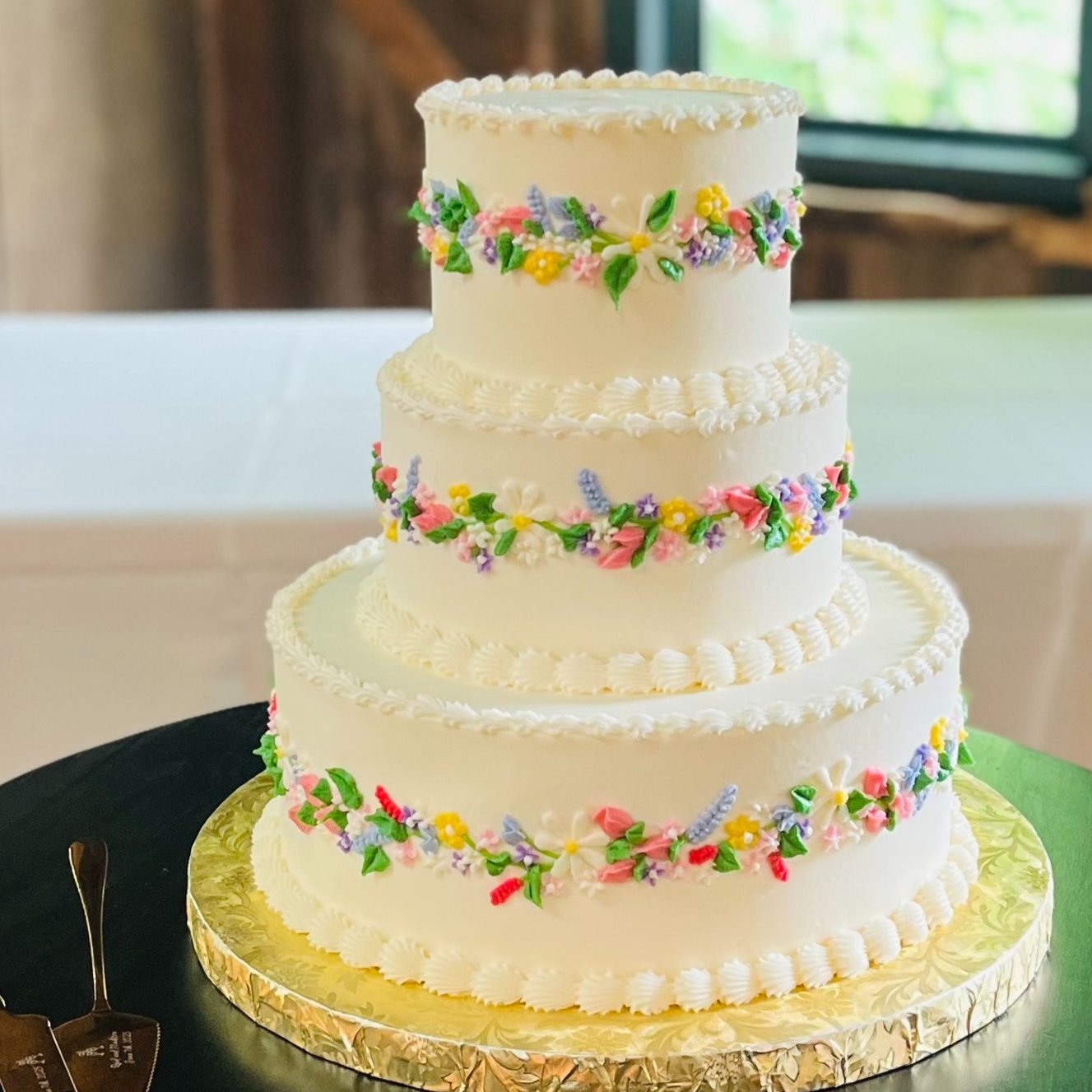 A three-tier buttercream wedding cake with hand-piped floral detail by Sweet Escape Cake Company in Indianapolis.