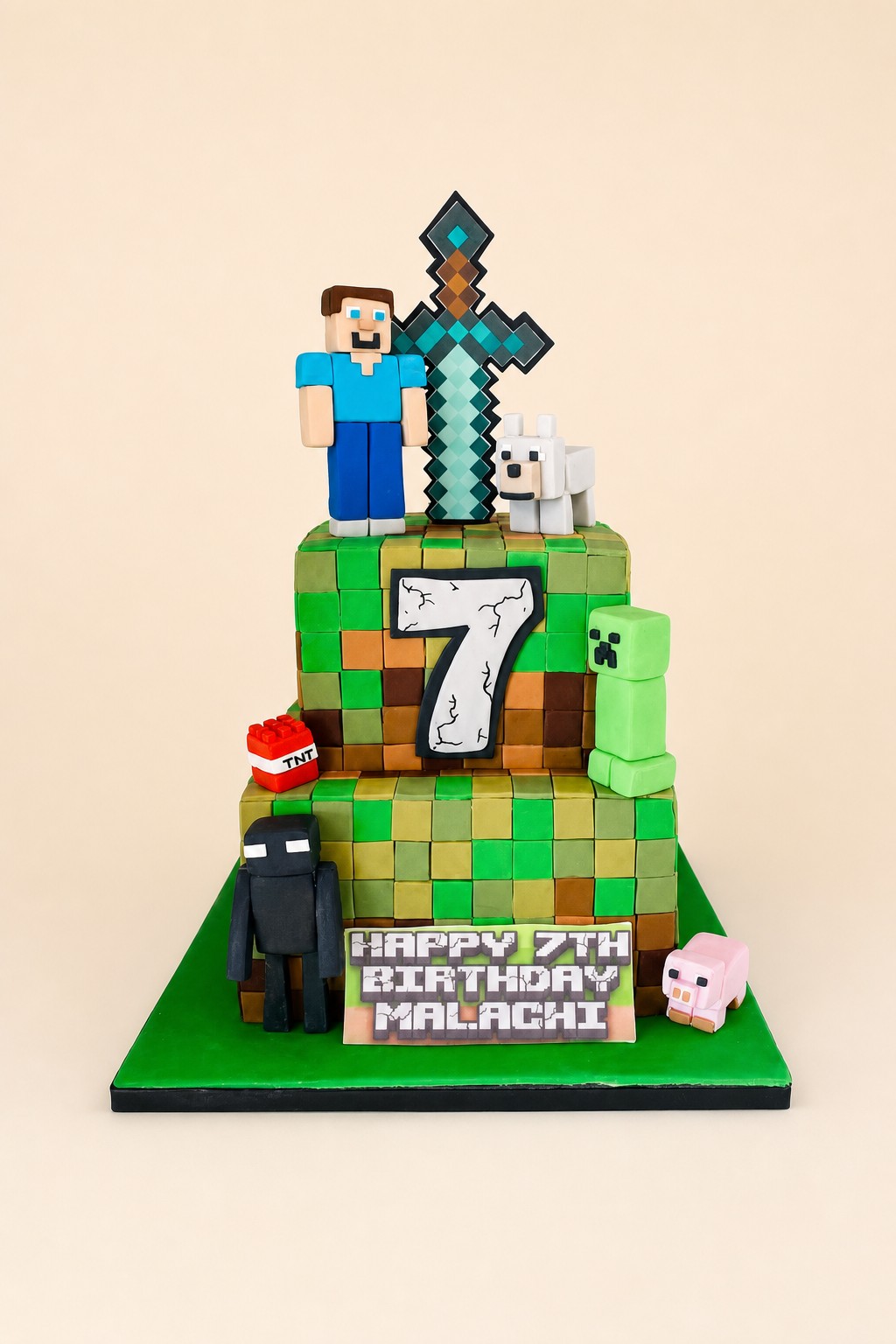 A two-tier square Minecraft-themed birthday cake for Malachi, featuring fondant blocks, pixelated characters like Steve, Creeper, Enderman, 