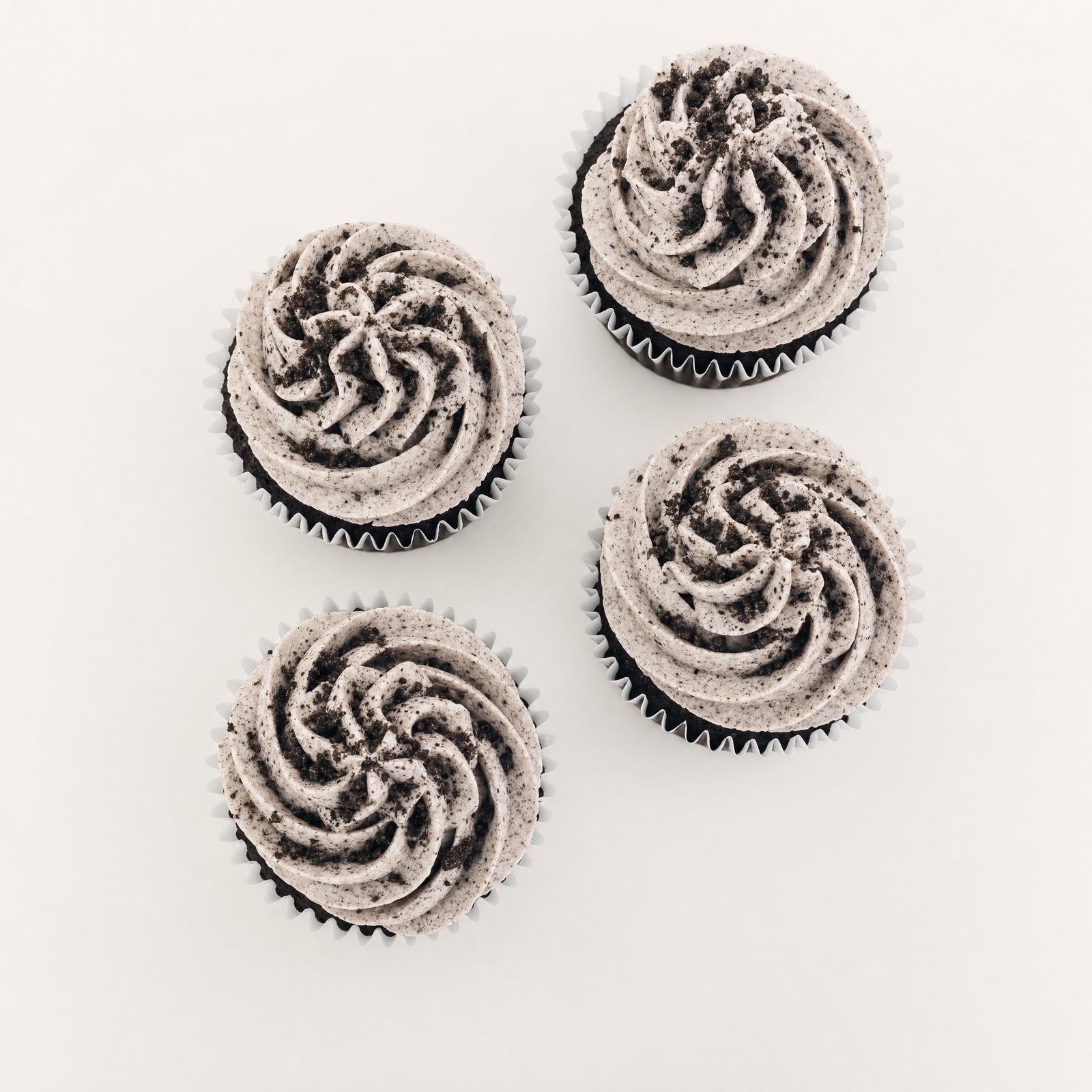 Delicious chocolate cupcakes topped with a swirl of cookies and cream buttercream frosting and sprinkled with crushed Oreo cookie pieces.