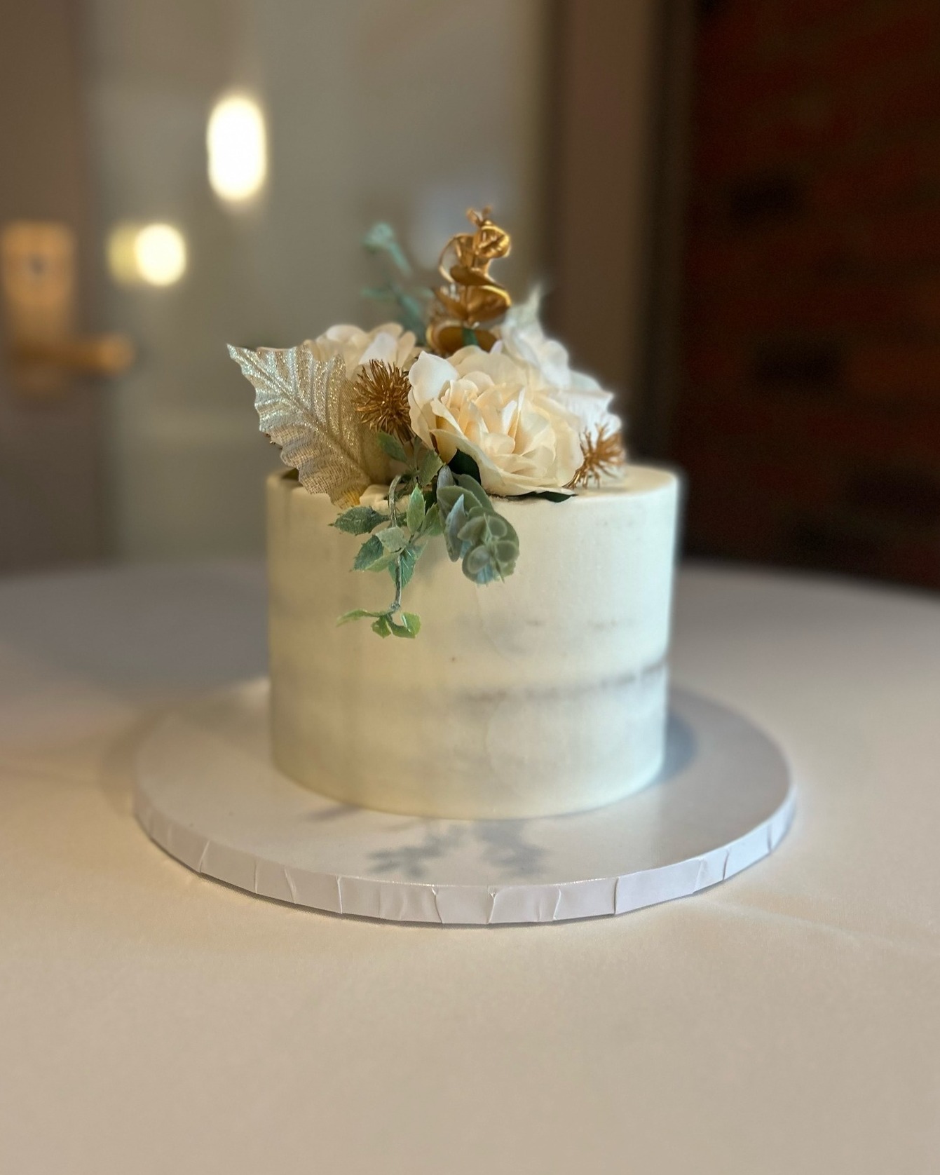 Naked cake with cream flowers